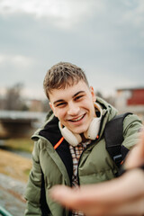 Young adult man student smiling take self portrait 
