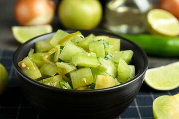 Delicious salsa (Pico de gallo) in bowl on table, closeup