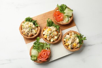 Tartlets with delicious fillings on white table, top view