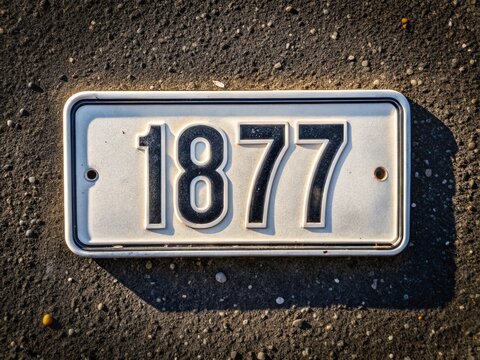 Aerial View of White License Plate Number 187 on Asphalt