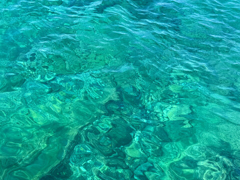 Sea water clear aquamarine blue surface.
