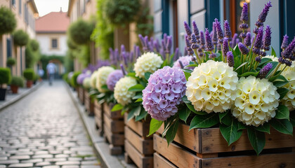Fototapeta premium Flower pots with purple and white blooms on cobblestone street