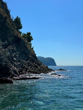 Layered rocks on sea shore. 