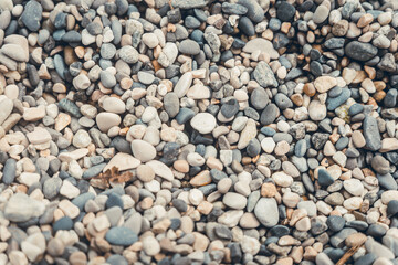 close-up of small pebbles at the beach, round pebbles, in the water of the lake in Savoie