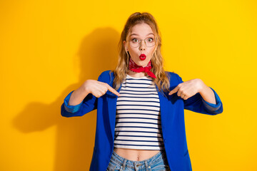 Blond Woman in Blue Jacket and Red Scarf Against Bright Yellow Background, Pointing at Herself