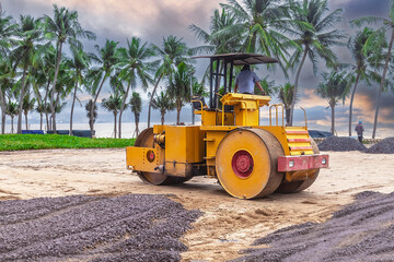 construction machine roller on a construction site. The machine is used to level sand.