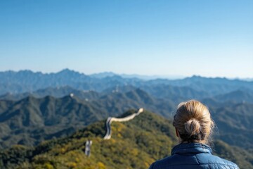 cinematic shot of traveler hiking along great wall of china with mountains stretching into horizon
