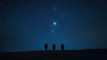 Three silhouetted figures stargazing under a vast night sky