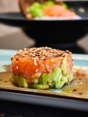 Delicate sushi tower with fresh fish and creamy avocado presented elegantly for a culinary experience