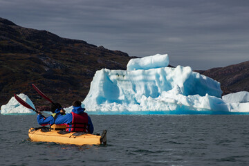 Kayaking in Tasiusaq ice fjord (South Greenland)