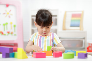 A young girl engages in creative construction toys at home