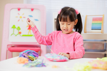 A young girl was creating a craft at home