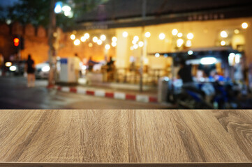 Empty dark wooden table in front of abstract blurred boken bankground of restaurant. Can used for display or montage your products. Mock up for space.	