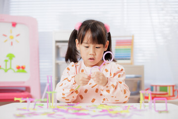 A young girl was making crafts at home.	
