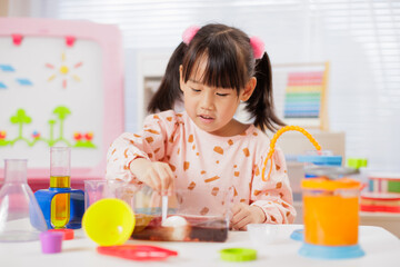 A young girl was conducting a science experiment at home.	
