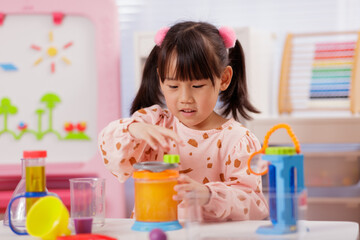 A young girl was conducting a science experiment at home.	
