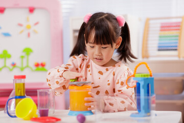 A young girl was conducting a science experiment at home.	

