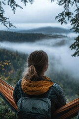 Fototapeta premium A person relaxing in a hammock, surrounded by fog and greenery