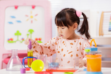 A young girl was conducting a science experiment at home.	
