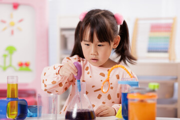 A young girl was conducting a science experiment at home.	
