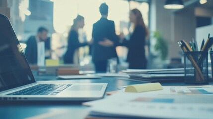 A laptop computer sits on top of a desk