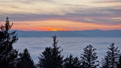 beautiful sunset visible from the mountain kluk mountain peaking from cloud inversion
