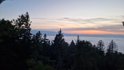 beautiful sunset visible from the mountain kluk mountain peaking from cloud inversion