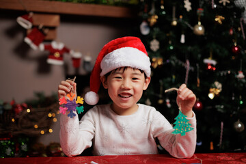 young girl making Christmas craft at home for celebrating Christmas