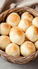 Small golden brown maamoul cookies, a traditional treat for eid al-fitr, are nestled together in a rustic wicker basket, creating a warm and inviting scene of festive indulgence