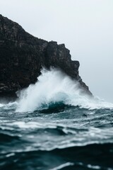 Powerful wave crashing against rocky coast. Scenic seascape for travel promotion