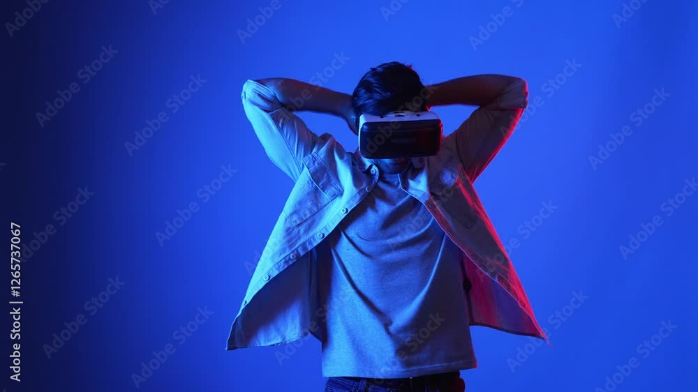 Poster smart gamer wearing vr goggles while holding sword and fencing in virtual world. attractive male mod