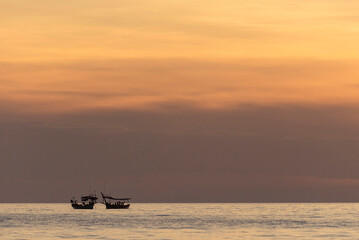 Two boats on the sea during sunset time