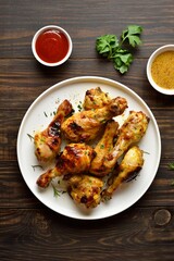 Barbecue roasted chicken drumsticks served with sauce