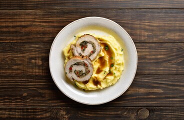 Pork loin stuffed with mushrooms, cheese, dried tomatoes in gravy sauce served with mashed potatoes