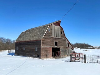 The classic Gambrel shaped livestock barn in the snow