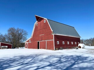 Almost a perfect red wood barn in the snow scene