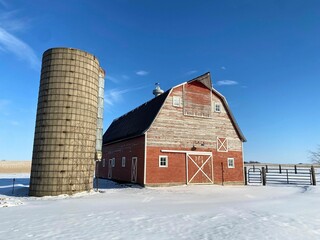 A barn snow scene so surreal it looks like a painting
