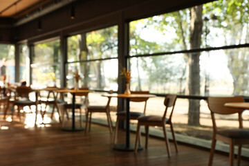 Blurred view of stylish cafe with large windows