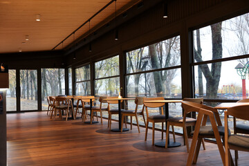 Stylish cafe with large windows and comfortable furniture. Interior design