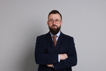 Handsome bearded man in suit on grey background