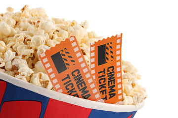 Tasty popcorn and movie tickets isolated on white