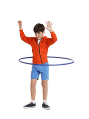 Boy exercising with hula hoop on white background