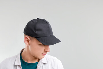 Man in stylish baseball cap on light grey background. Mockup for design