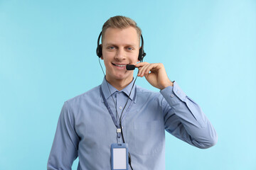 Technical support call center. Portrait of smiling operator on light blue background