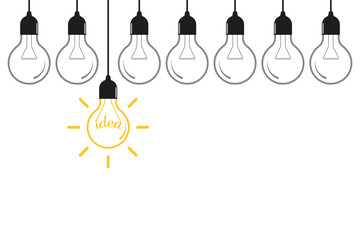 Creative idea concept. Hanging light bulb with  handwritten "idea" text on yellow background
