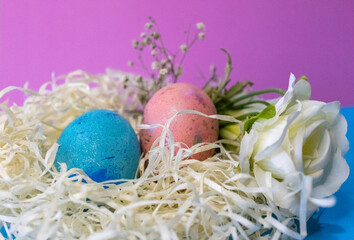 Side view of hand painted eggs and flowers. Pastel shades