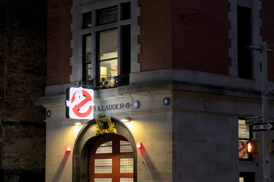 Firehouse, Hook and Ladder Company 8 with ghostbusters logo at night in Manhattan New York City.