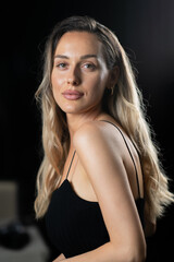 Naklejka premium Radiant Elegance: A Stunning Blonde in a Black Dress Exuding Confidence and Beauty.