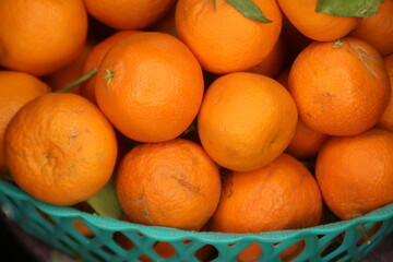 Fresh tangerines in plastic basket