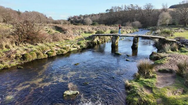 Postbridge Dartmoor Devon England UK. 10.02. 2025. Video. Overview of the East Dart River flowing towards  a clapper bridge on Dartmoor Devon UK.